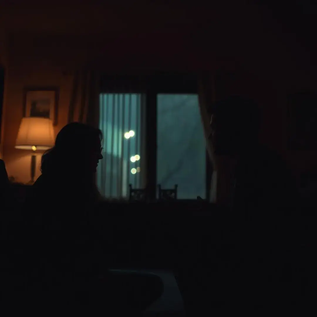 Dimly lit room with couples discussing during a power outage.